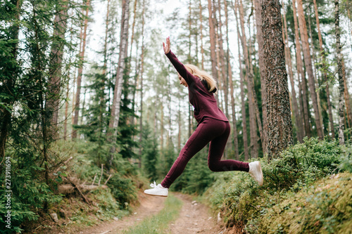 Sportive woman jumping in forest © benevolente