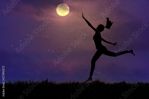 Silhouette, a young woman clutching the moon in open grassland, concept pursues dreams.