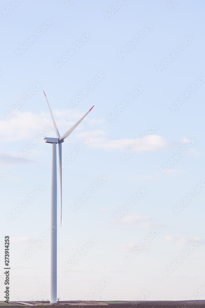 One wind turbine with cloudy sky in background One wind turbine with cloudy sky in background