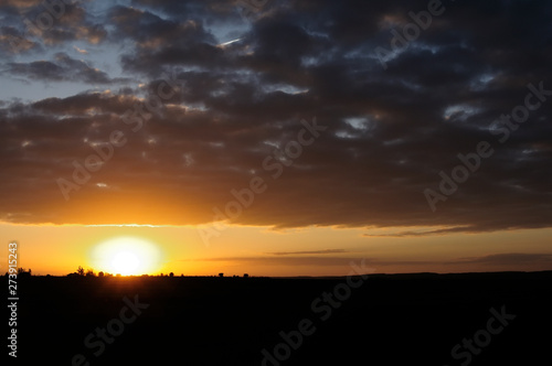 Sunrise in the countryside. A day dawns. The orange contrast of the sun with the darkness of dawn. It makes this landscape something beautiful. The black melts with the sun