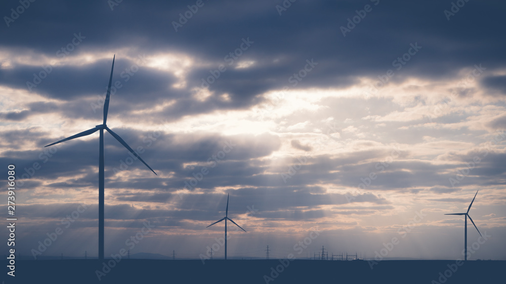 Wind warm on agricultural ground with cloudy sky in background