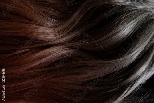Beautiful hair. Long curly dark hair. Coloring with gradient from red to black.
