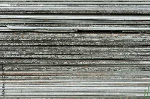 Tile roof slate stacked for use in home construction. Construction asbestos-cement slates. Stack of ceramic pattern background