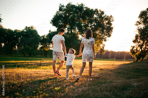 family walk in the Park at sunset