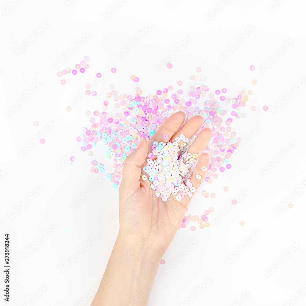 Pearl pastel confetti sparkles with woman hand Pearl pastel confetti sparkles with woman hand