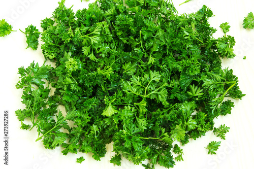 Fresh parsley leaves on a white background. Natural background. Top view.