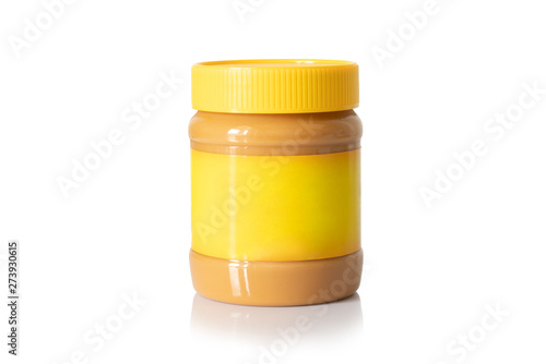 Jar of creamy peanut butter with yellow cap and yellow label isolated on white background. Mock up
