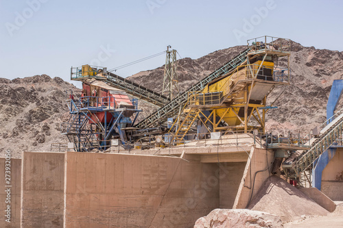 industrial capacity of disabled and abandoned digging factory and machines in Middle East dry desert polluted outdoor environment 