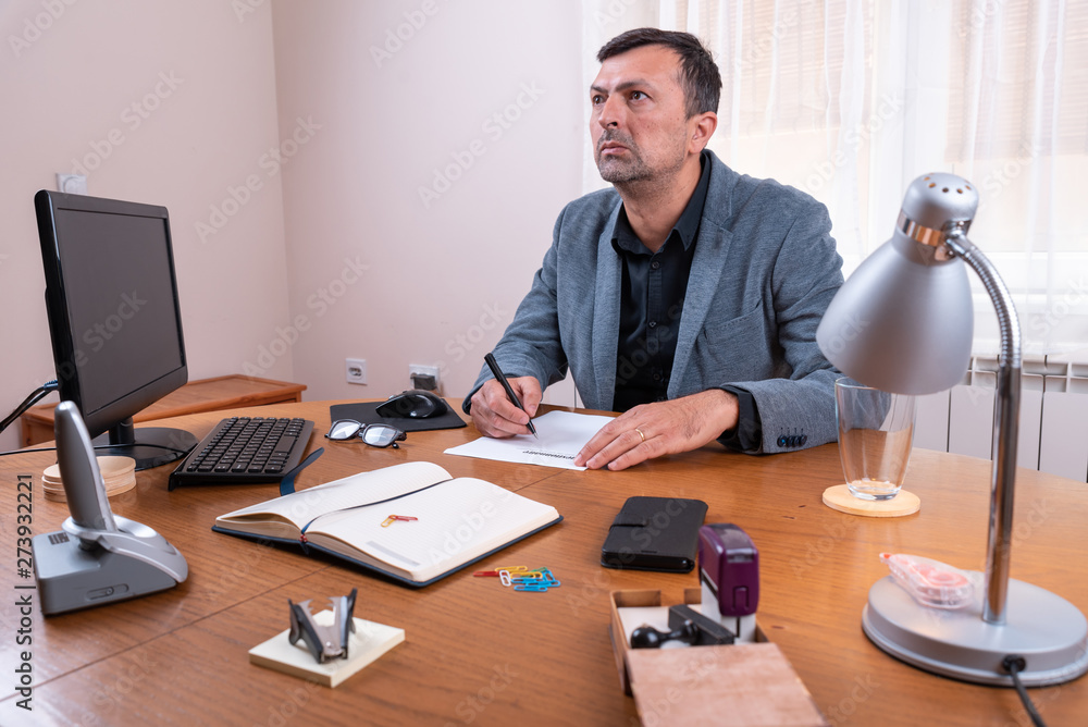 a man in a suit filled in the paper, 