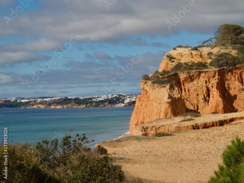 Red high cliffs at Praia da Falesia, a paradise beach in Albufeira in Portugal