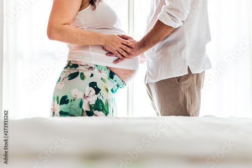 Man touching belly of pregnant woman
