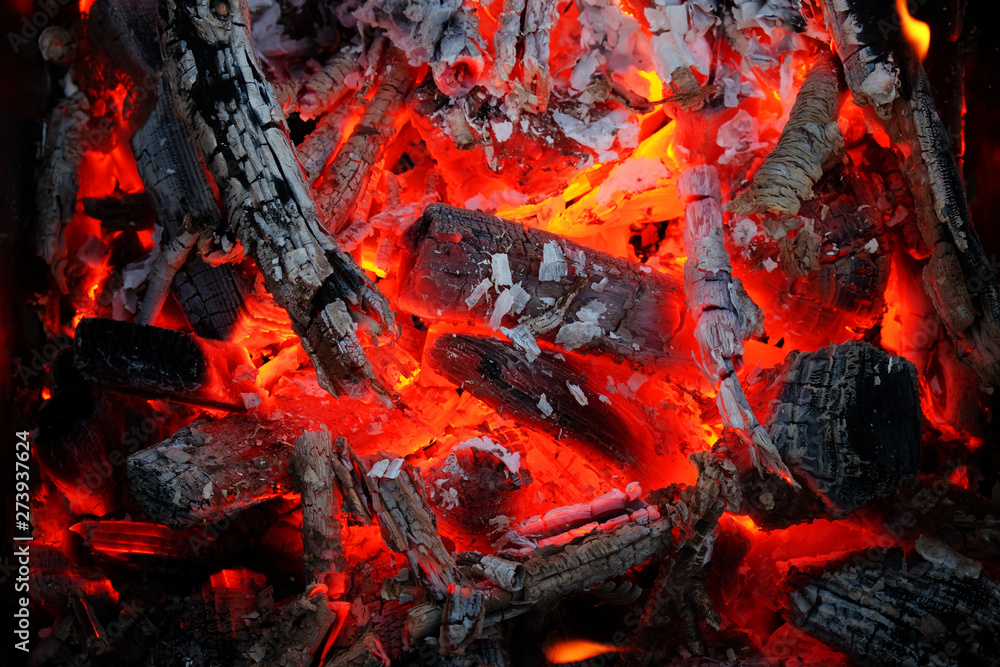 Glowing embers in hot red color, abstract background. The hot embers of burning wood log fire. Firewood burning on grill. Texture fire bonfire embers. Glowing embers in hot red color, abstract background. The hot embers of burning wood log fire. Firewood burning on grill. Texture fire bonfire embers.