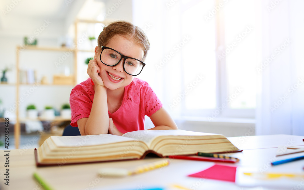 funny child girl doing homework writing and reading at home funny child girl doing homework writing and reading at home