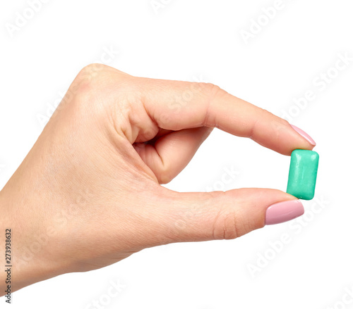Hand with bright chewing gum, dental bubblegum.