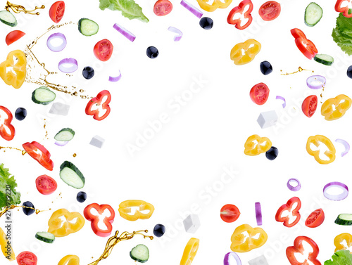 Fresh salad with flying vegetables ingredients isolated on a white background.Red tomatoes, pepper, cheese, lettuce, cucumber, olives and olive oil.