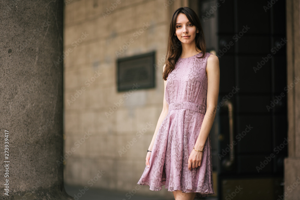 beautiful young girl in dress is resting outdoors, woman is walking on the street