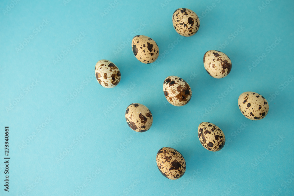 Raw quail eggs against blue background. Easter. Raw quail eggs against blue background. Easter.