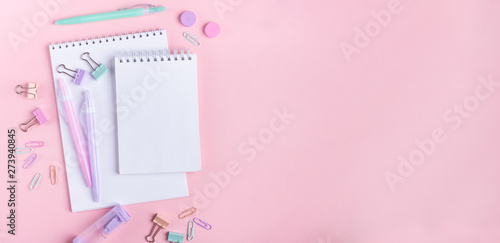 School background with notebooks and pastel colorful study accessories on pink background Back to school concept with copy space for text Banner