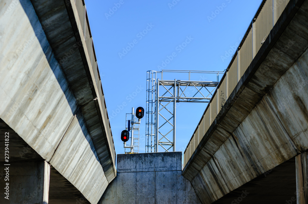 Train signals between cement bridges. Train signals between cement bridges.