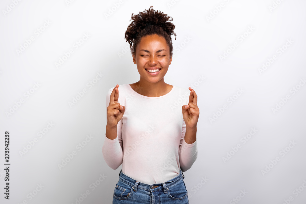 Cute woman crossing her fingers and wishing for good luck - Image Cute woman crossing her fingers and wishing for good luck - Image