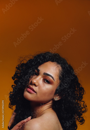 Portrait of Beautiful Young Guatemalan with mustard background