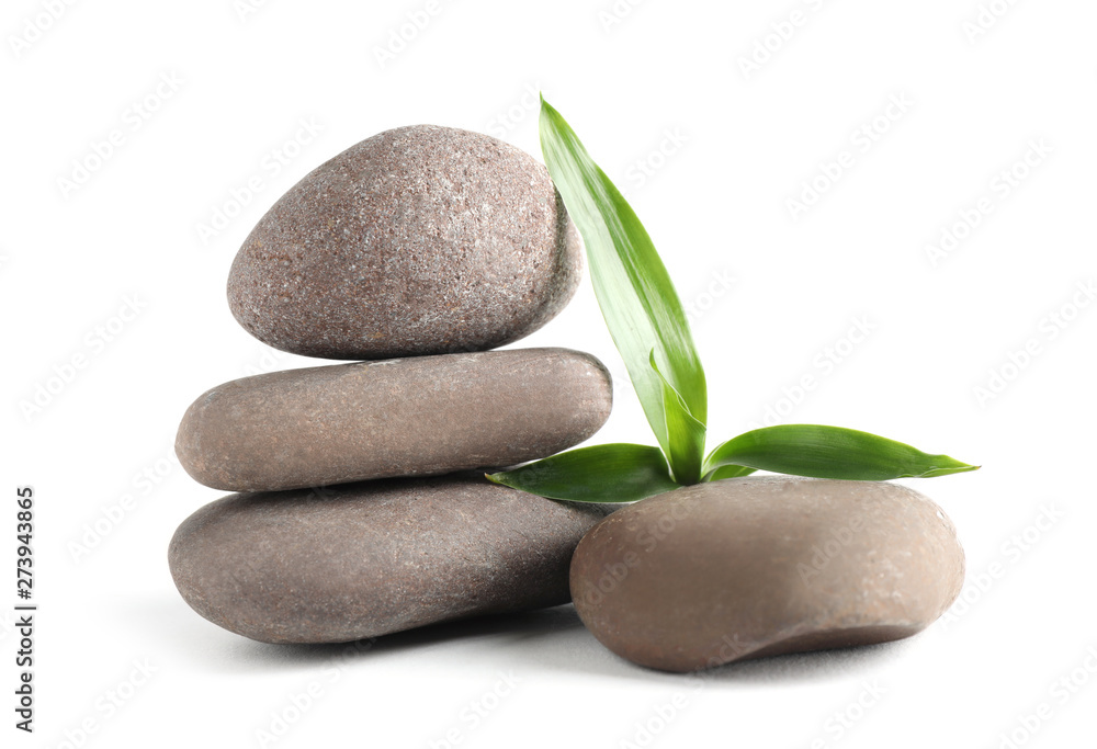 Stack of spa stones with bamboo isolated on white Stack of spa stones with bamboo isolated on white
