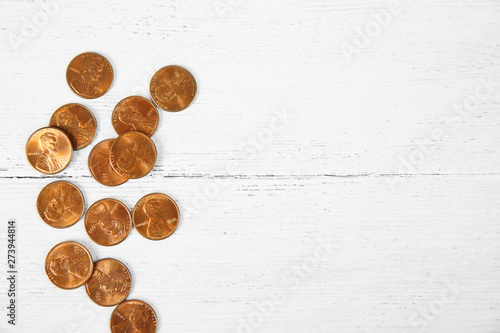 Photos Many coins on wooden table, top view. Space for text