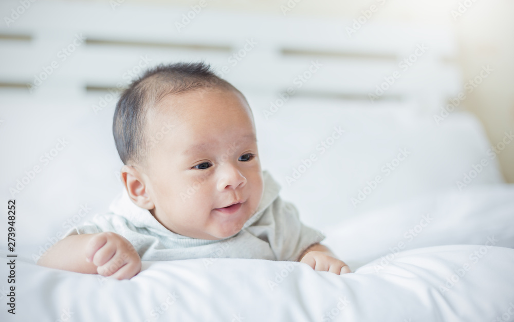 Closeup portrait of asian happy baby over white bed, Family love newborn hospital healthcare daycare nursery concept. Closeup portrait of asian happy baby over white bed, Family love newborn hospital healthcare daycare nursery concept.