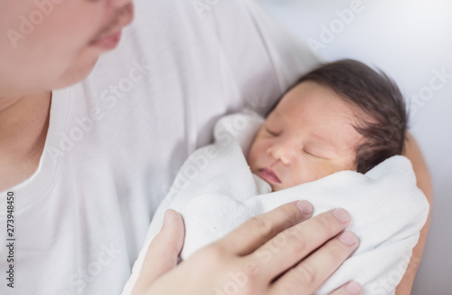 Portrait of young asian father holding his newborn baby with copy space. Healthcare and medical nursery love lifestyle together single dad father’s day holiday concept (blur)