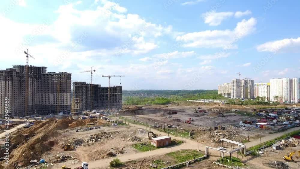 Drone flies over a construction site near Moscow. Construction cranes in the industrial zone. Building a new area. Drone flies over a construction site near Moscow. Construction cranes in the industrial zone. Building a new area.