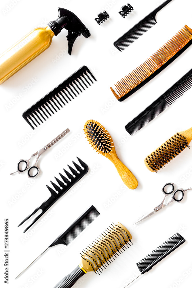 Combs, sciccors and hairdresser tools in beauty salon work desk on white background top view pattern Combs, sciccors and hairdresser tools in beauty salon work desk on white background top view pattern