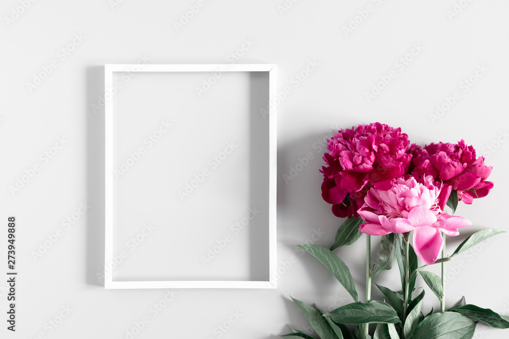 Beautiful flowers composition. Blank frame for text, red peonies flowers on gray background. Flat lay, top view, copy space Beautiful flowers composition. Blank frame for text, red peonies flowers on gray background. Flat lay, top view, copy space