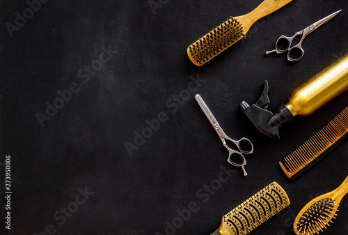 Combs and hairdresser tools in beauty salon work desk on black background top view mockup