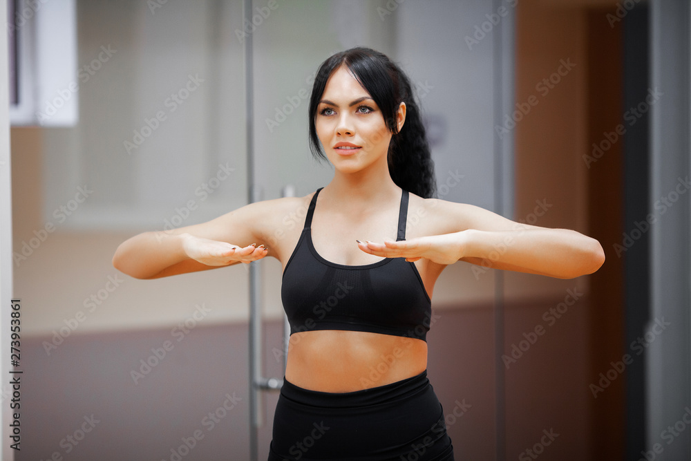 Fitness woman. Sports girl in the gym doing exercises