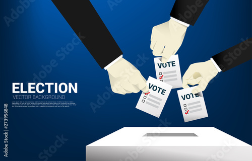 close up businessman hand put their vote to  election box. concept for election vote theme background.
