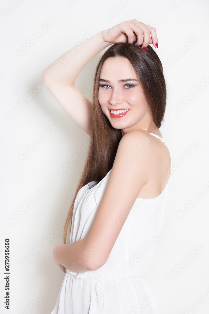 woman in white dress holds hands around herself woman in white dress holds hands around herself