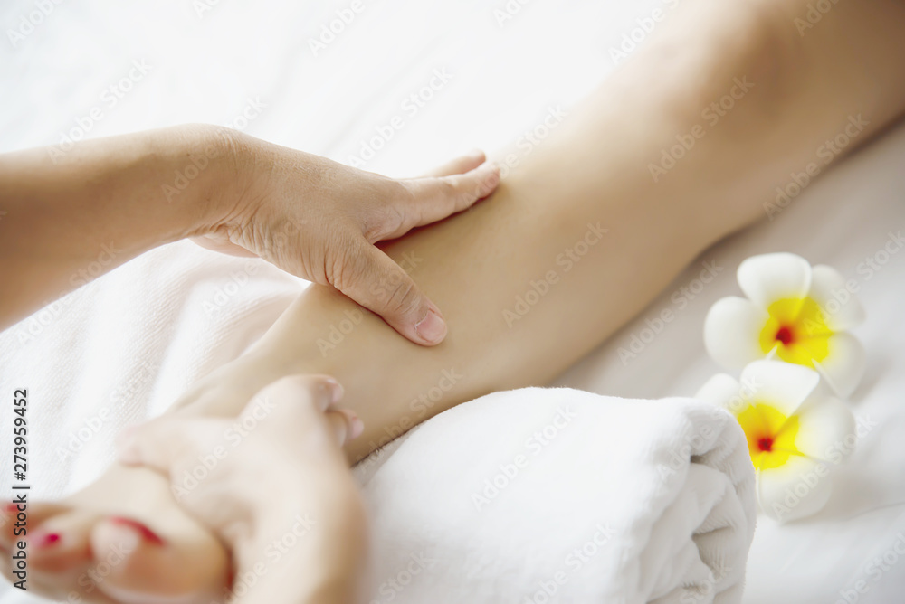 Fototapeta premium Woman receiving foot massage service from masseuse close up at hand and foot - relax in foot massage therapy service concept