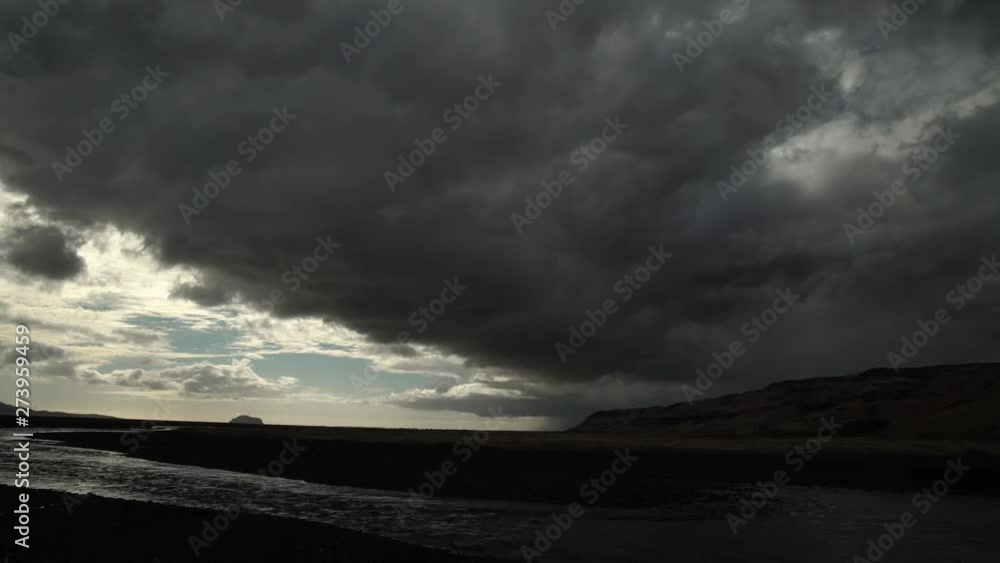 Dark ominous storm clouds over glacial river landscape Iceland.mov Dark ominous storm clouds over glacial river landscape Iceland.mov