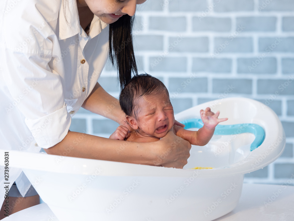 Mother bath Asian boy baby newborn on the bathtub Mother bath Asian boy baby newborn on the bathtub