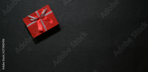 Red gift box on dark top table