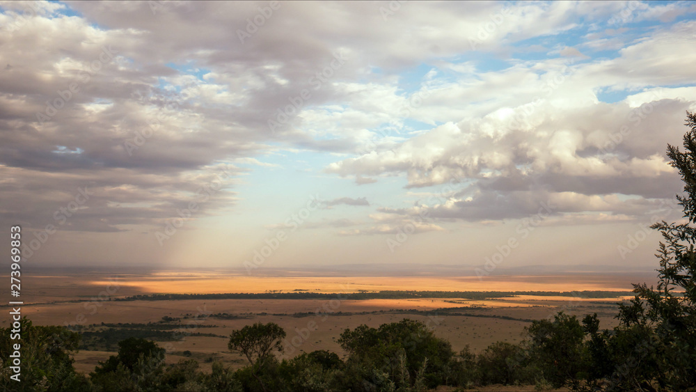 savanna and clouds at maasai mara game reserve, kenya