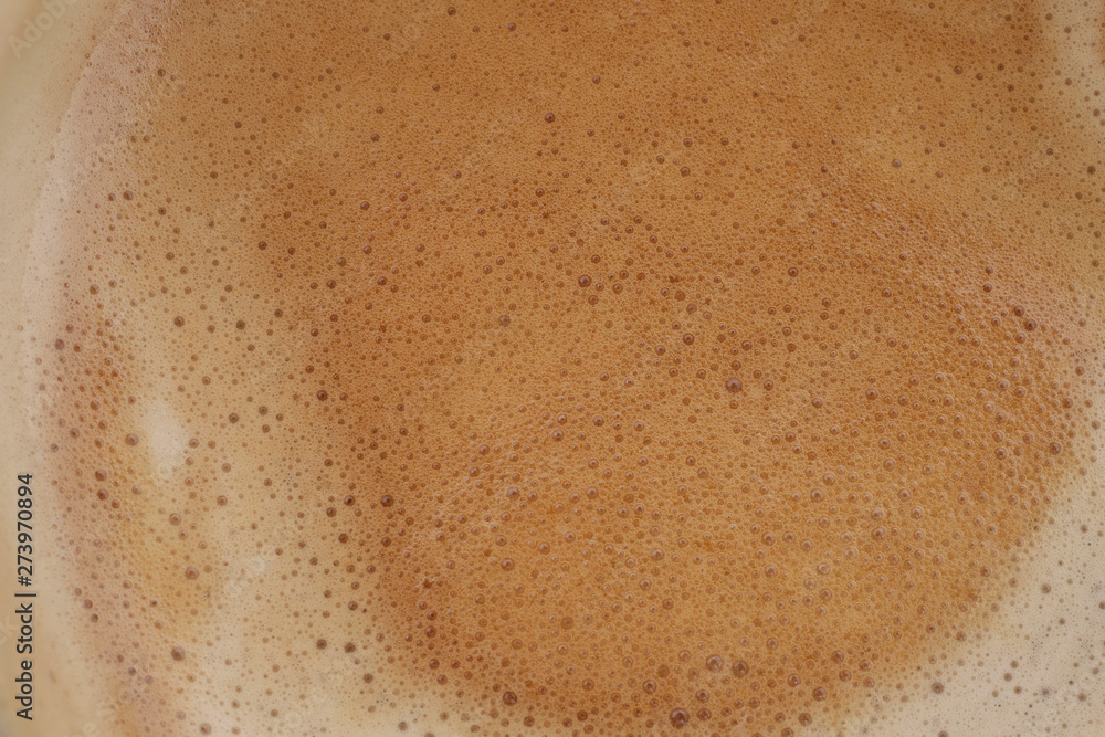 Background of coffee foam texture. Horizontal, cropped shot, top view, close-up. Coffee concept Background of coffee foam texture. Horizontal, cropped shot, top view, close-up. Coffee concept