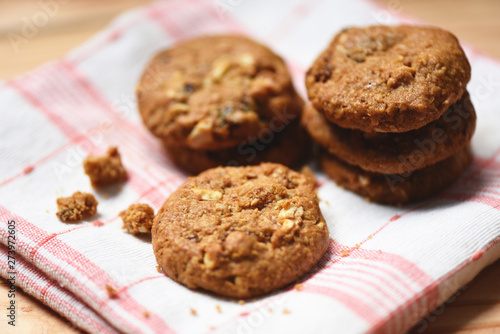 cookies dried currants and nut on tablecloth on wooden table © Bigc Studio