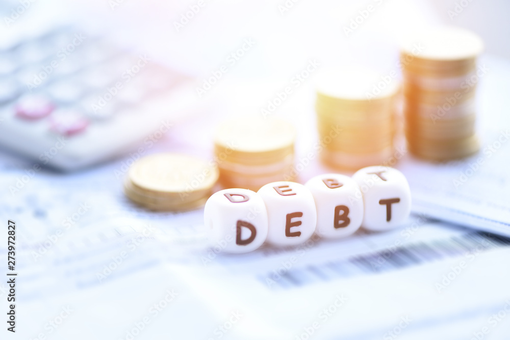 Debt concept with calculator stack coin on invoice bill paper / Increased liabilities from exemption debt consolidationof financial crisis Debt concept with calculator stack coin on invoice bill paper / Increased liabilities from exemption debt consolidationof financial crisis