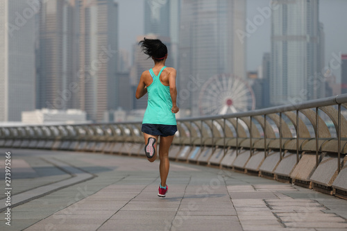 Healthy lifestyle woman runner running at hong kong city in the morning