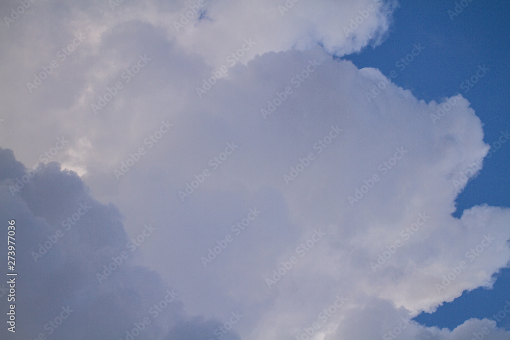 Background of blue sky with white cumulus clouds