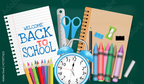 Back to school concept with school supplies on chalkboard background