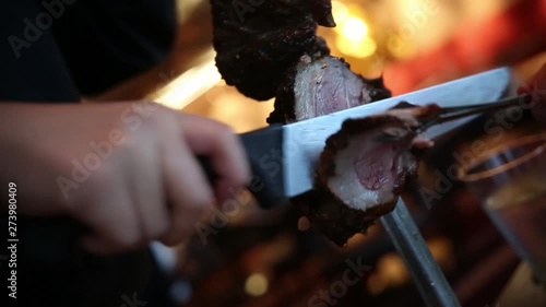 Close up shot of lamb being sliced in a churrascaria restaurant photo