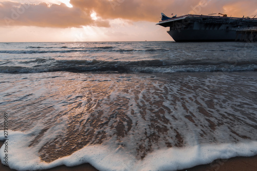 sunset ,North Beach in Corpus Christi, Texas, USA with aircraft carrier ship