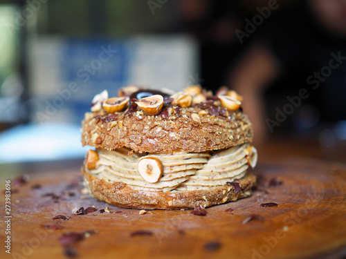 Fotografie Paris Brest, a classic French dessert consist of large baked ring of choux pastry, filled with soft hazelnut cream topped with roasted hazelnut